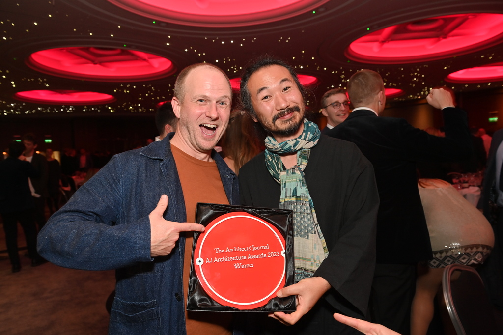 Two men posing for the camera at an event. One is holding a plaque that reads "The Architects' Journal AJ Architecture Awards 2023 Winner"