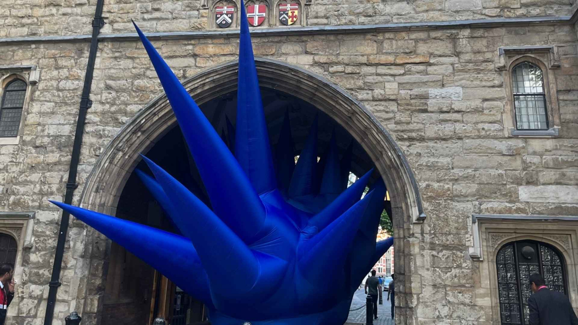 Eye-catching inflatable blue installation at Clerkenwell Design Week, set against the historic stone facade of a London gateway."