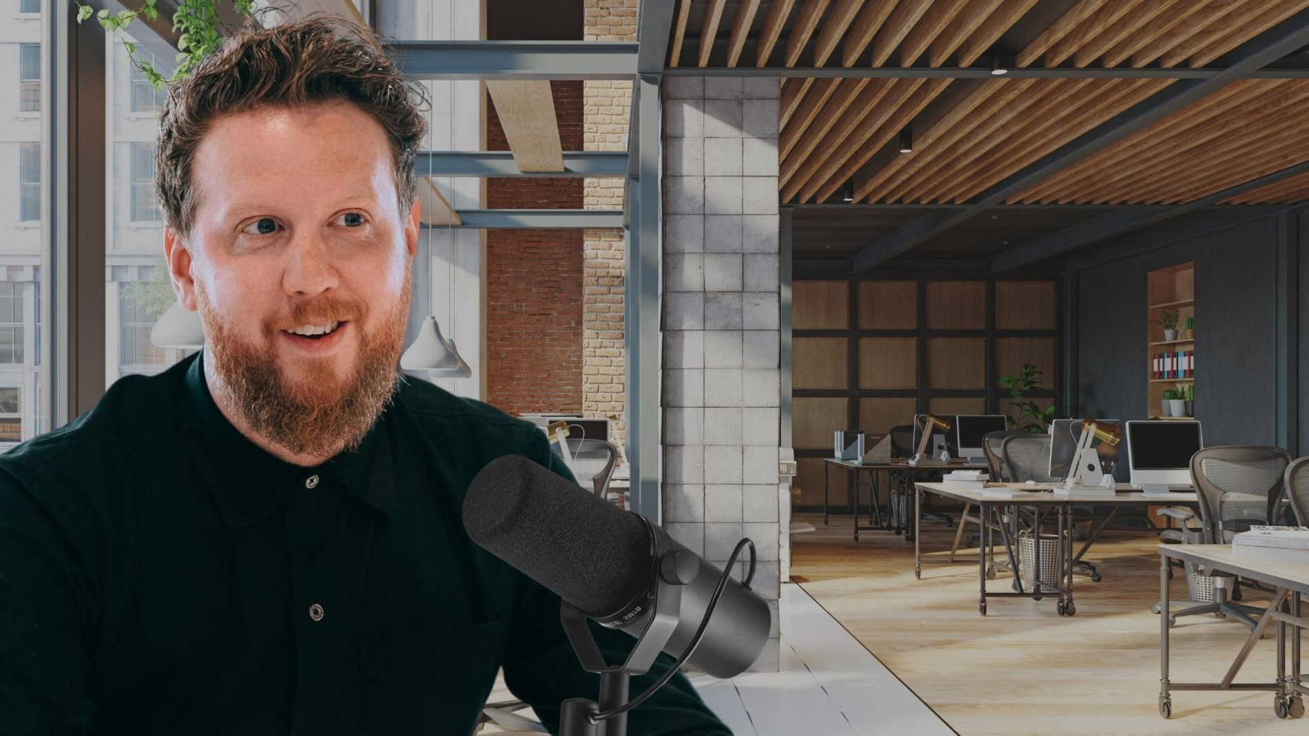 Person speaking into a microphone in a modern, open-plan office with industrial design elements, featuring exposed brick walls, wooden ceilings, and large windows.