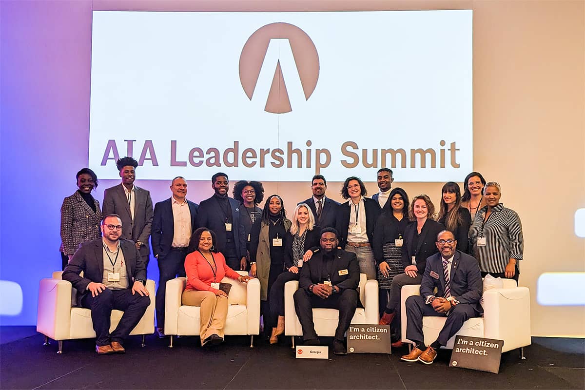 Group photo of attendees at the AIA Leadership Summit 2023, featuring professionals from the architecture industry gathered on stage.