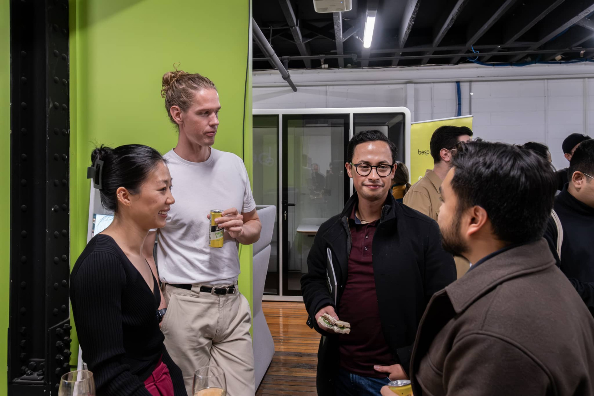 A group of people engaged in conversation at a professional or social event.