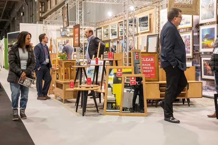 A wide-angle view of the exhibition hall at the January Furniture Show 2025, showcasing various furniture displays and attendees.