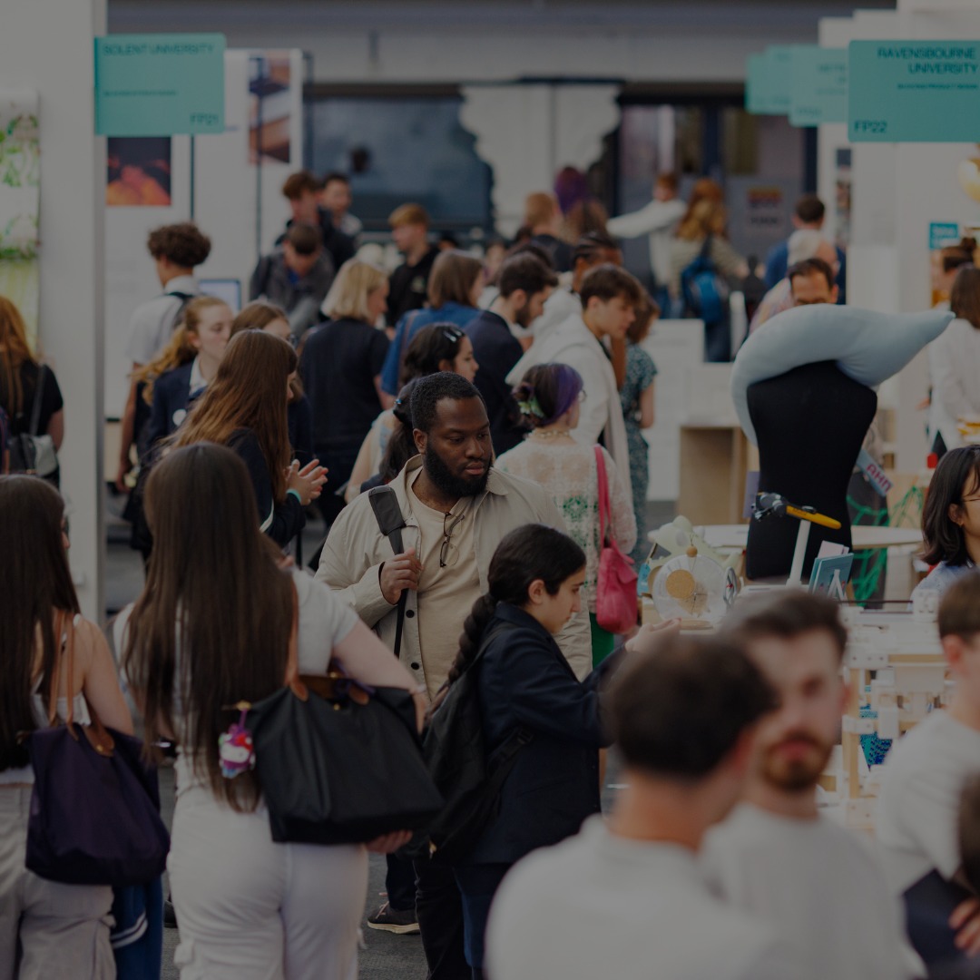 Attendees exploring exhibits and networking at a bustling design event, showcasing innovative projects and university showcases.