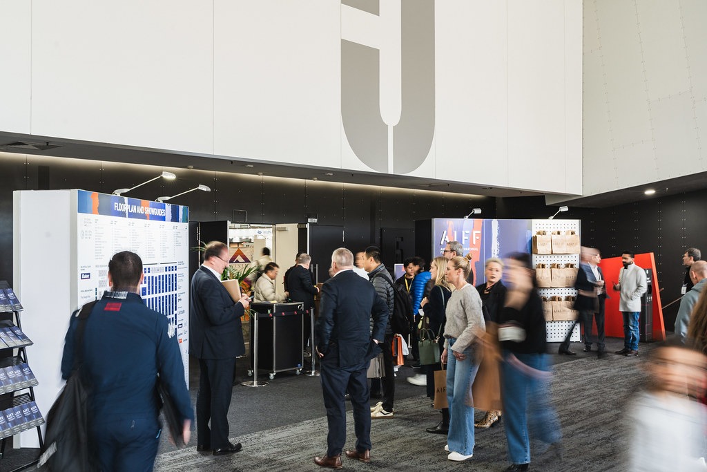 People at registration desk for the Australian International Furniture Fair (AIFF).