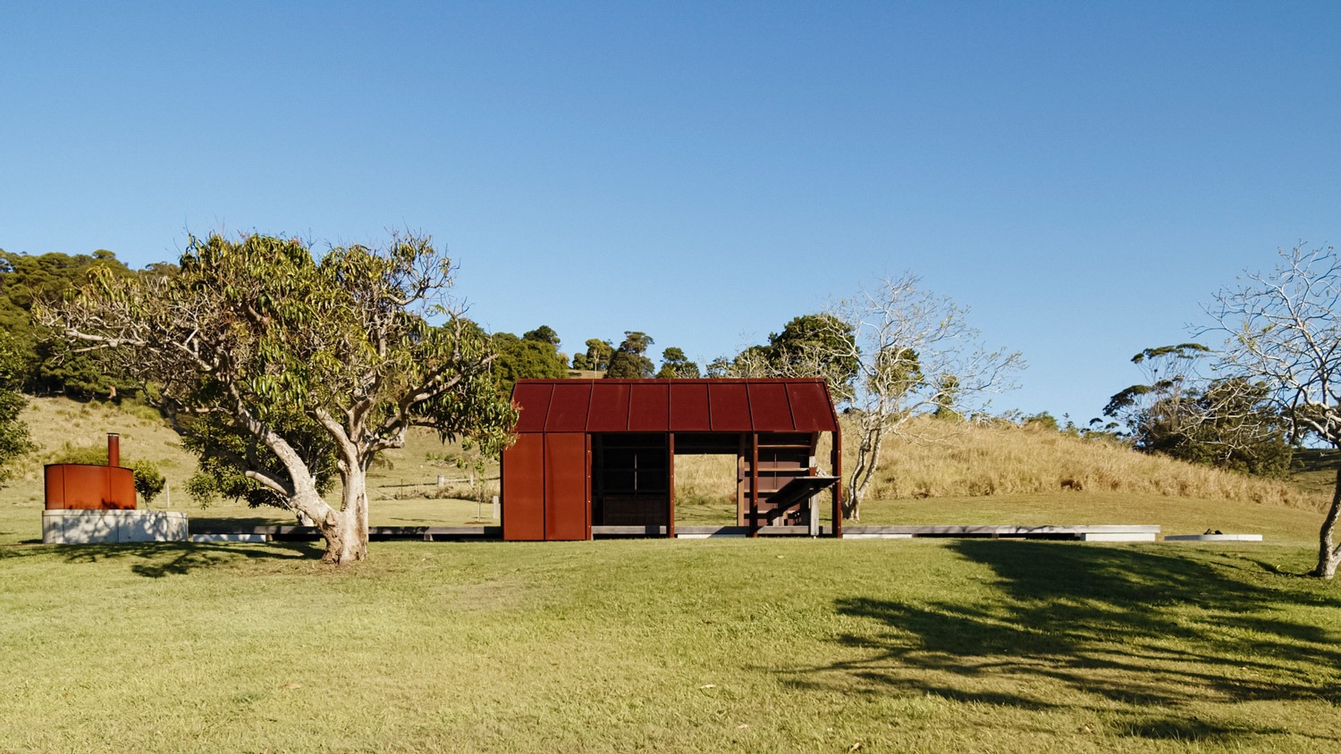 Photo of small timber building in a field
