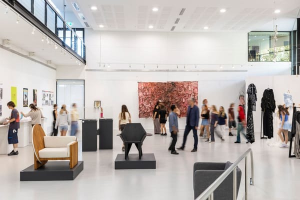 Photo of a exhibition space with furniture and artwork