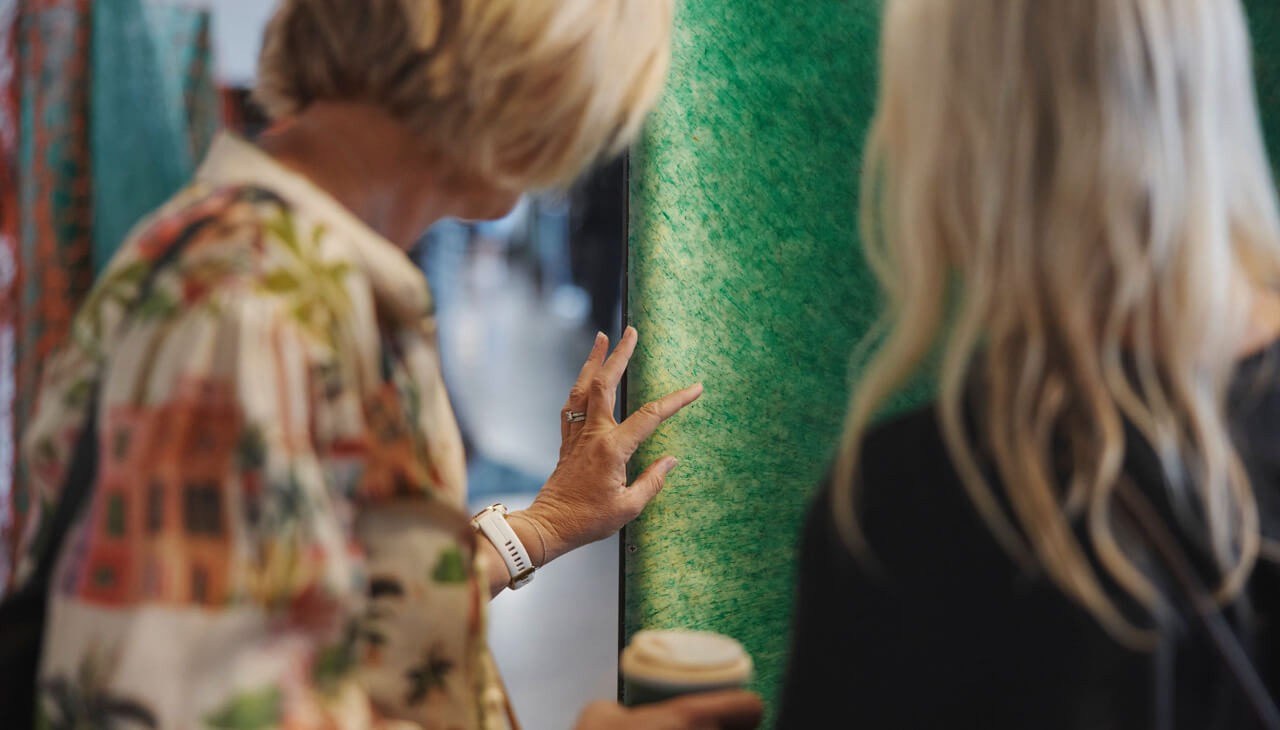 two people feeling a green fabric