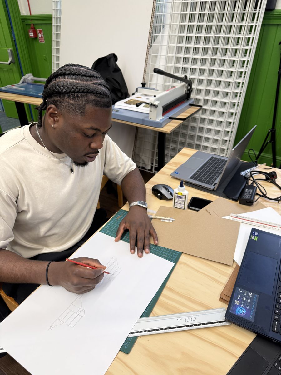 Noris Obijiaku sketching at his desk