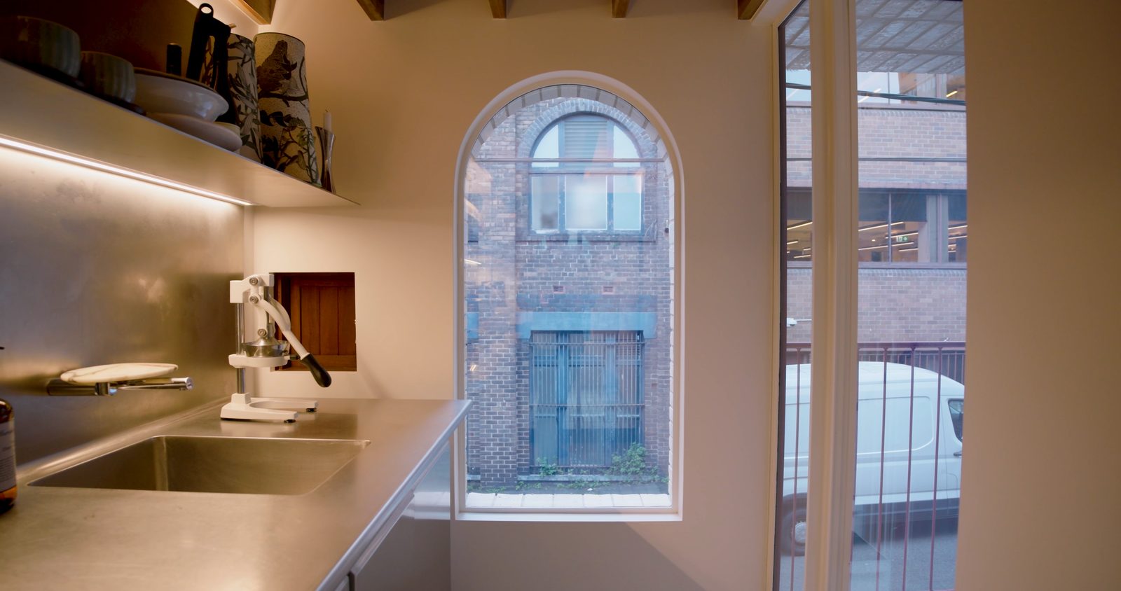 The kitchen with its arched window