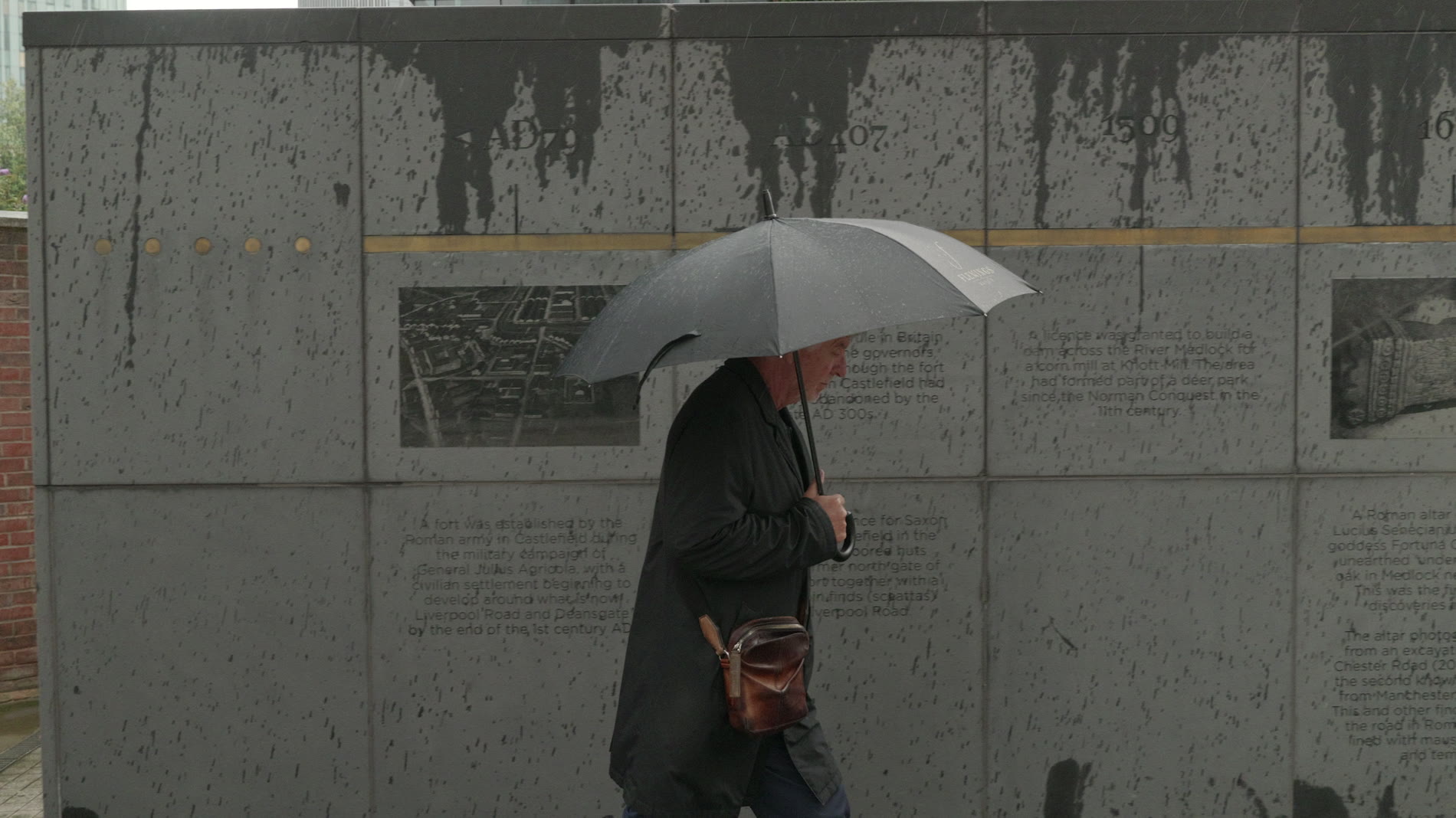 Ian Simpson walking to the office in the rain