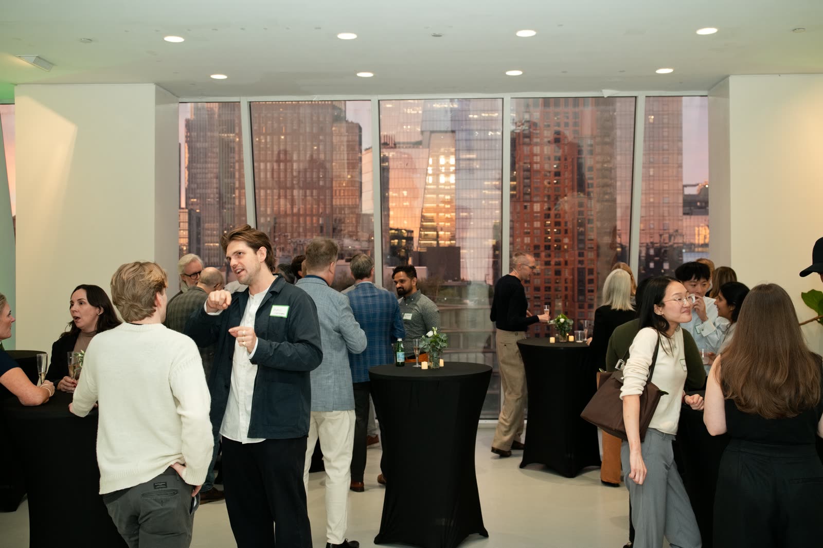 Guests at the Bespoke New York office launch with the skyline at dusk