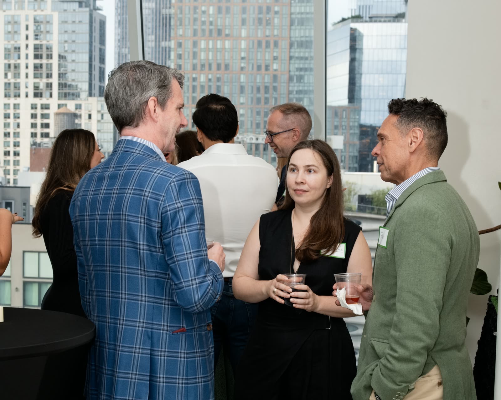 Guests talking by the windows at the Bespoke New York office launch