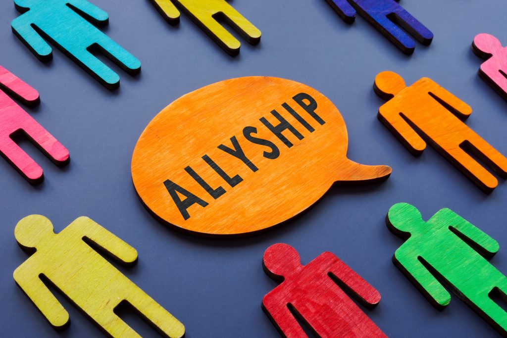 Allyship concept on the quote plate and figures.