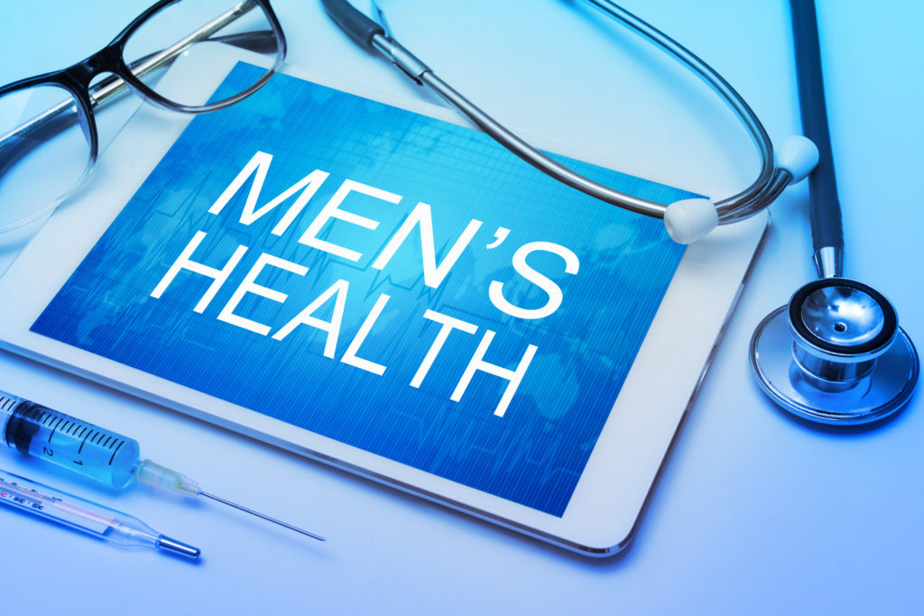 Men's health word on tablet screen with medical equipment on background
