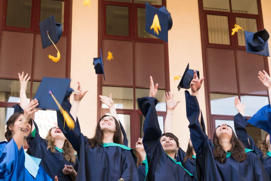 Graduates throwing hats celebrating V7 Recruitment